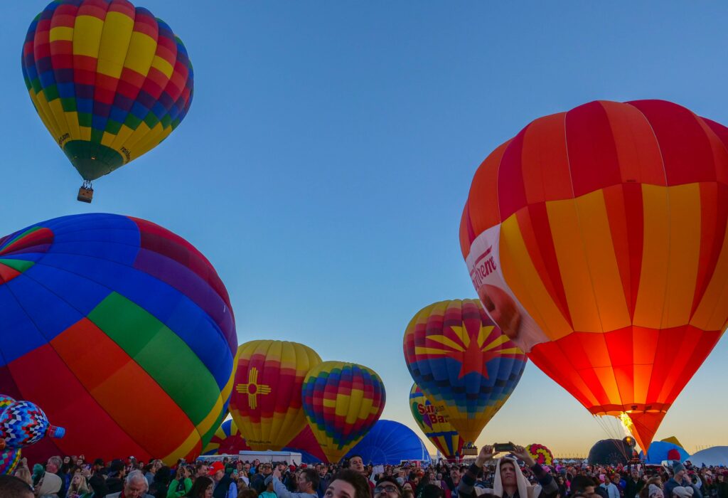 Balloon festival in New Mexico in 2022 - multiple balloons lifting off at dawn. 