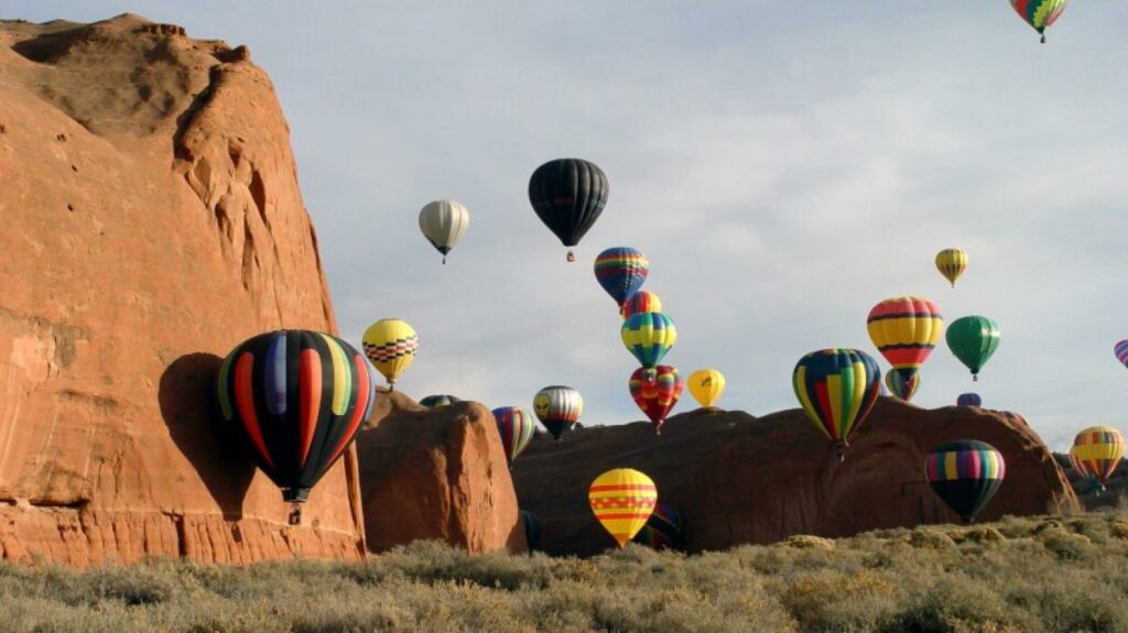 Hot air balloons expertly navigating the Red Rock formations at the Red Rock Balloon Rally.